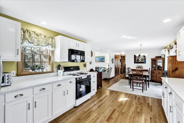 a living room with furniture wooden floor and a flat screen tv
