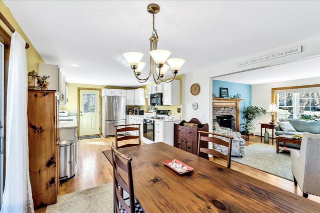 a living room with fireplace furniture and a chandelier