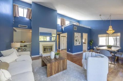a living room with furniture fireplace and a large window