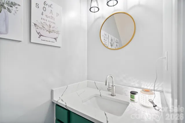 a bedroom with a bed and a flat tv screen on dresser