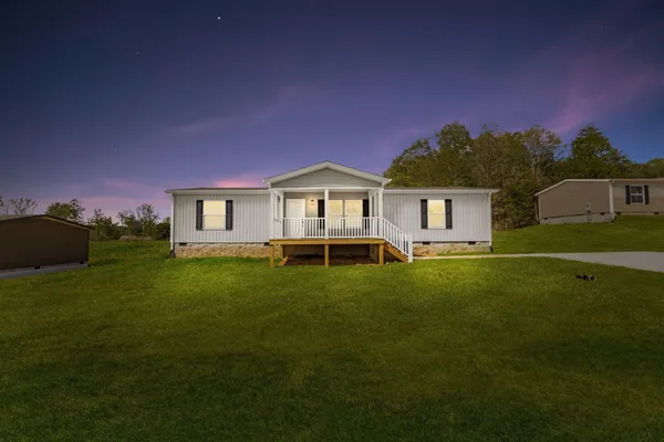 a view of a house with a backyard