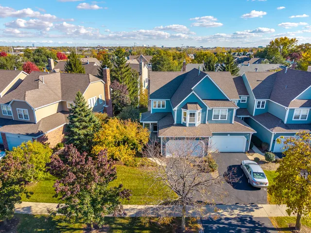 a aerial view of a house with a yard basket ball court and outdoor seating
