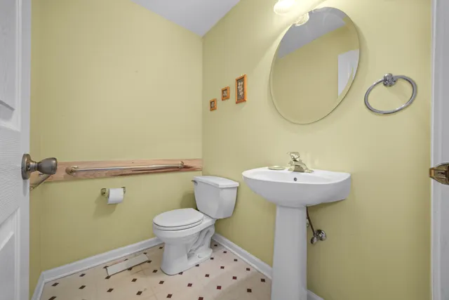 a bathroom with a sink toilet and a mirror