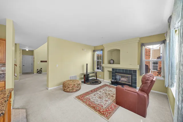 a living room with furniture a fireplace and a table