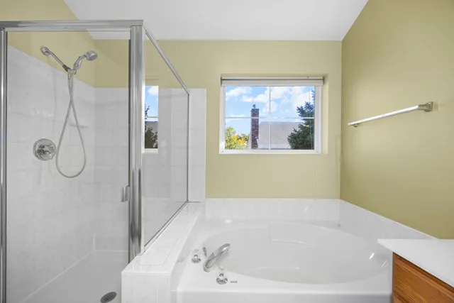 a bathroom with a bathtub and a shower