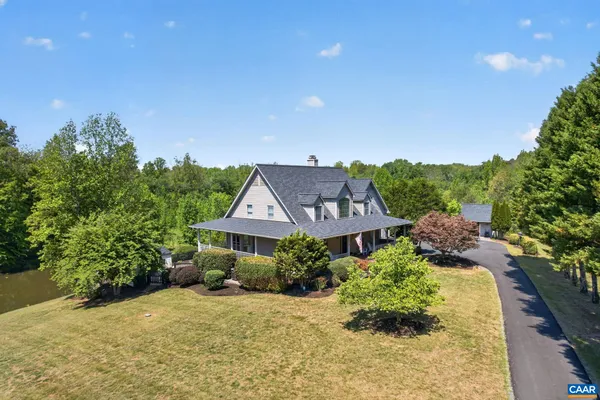 an aerial view of a house with a yard and potted plants