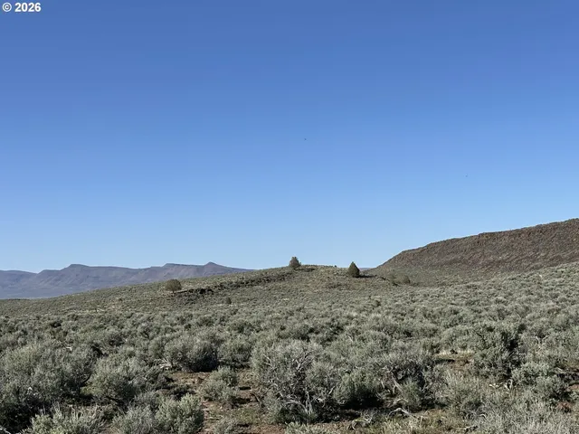 a view of a large mountain with mountains in the background