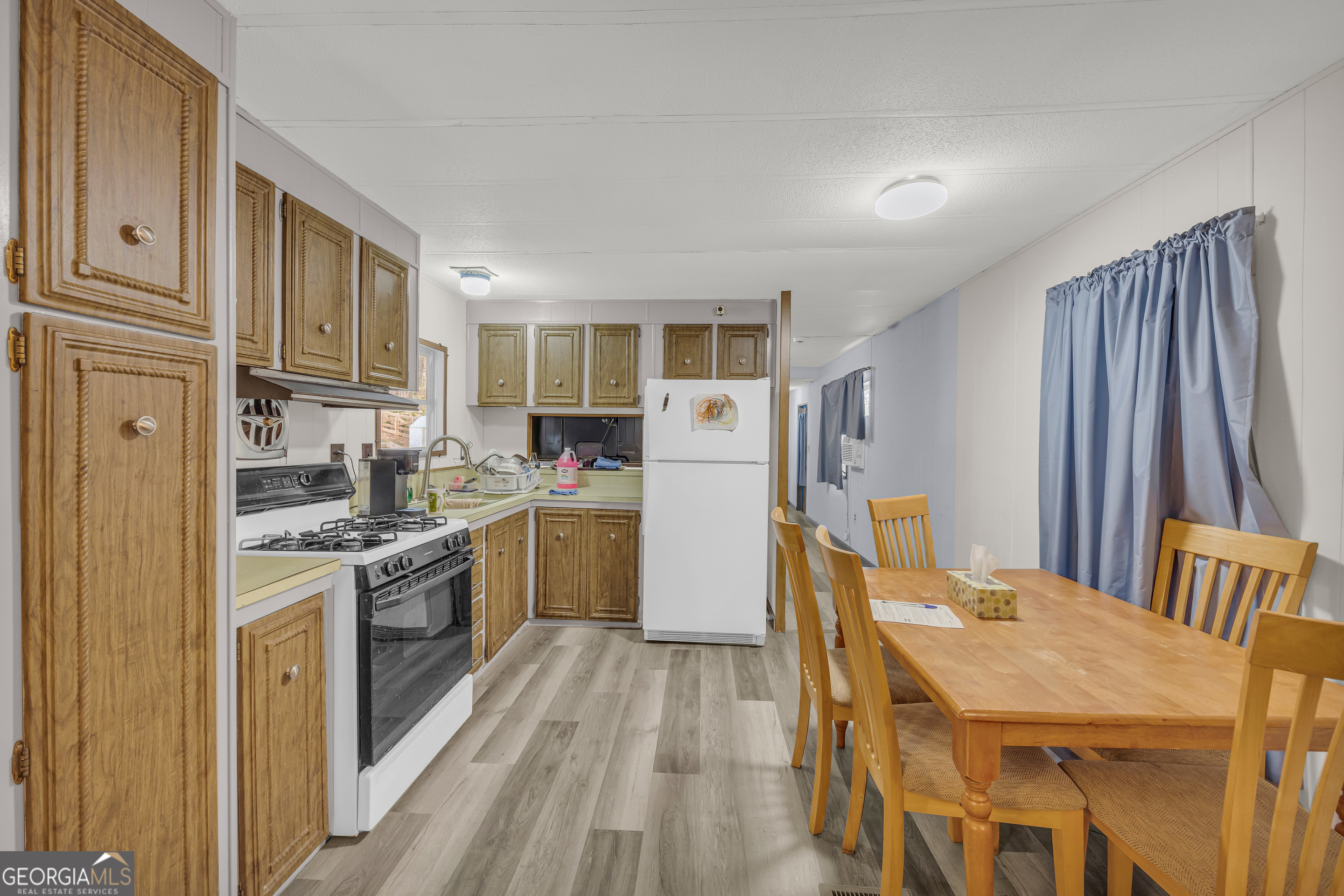39 Valley View Drive Lavonia, GA 30553 - Photo 10 of 33 a kitchen with stainless steel appliances granite countertop a refrigerator a stove top oven a sink dishwasher and white cabinets with wooden floor
