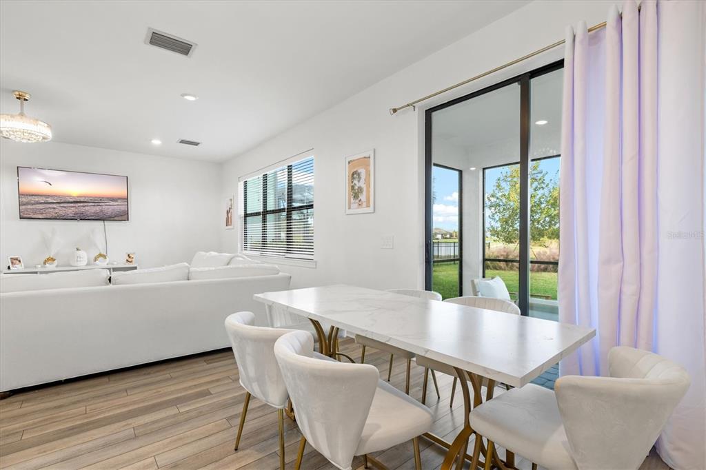 16235 Pine Mist Drive Bradenton, FL 34211 - Photo 15 of 100 a view of a dining room with furniture and window