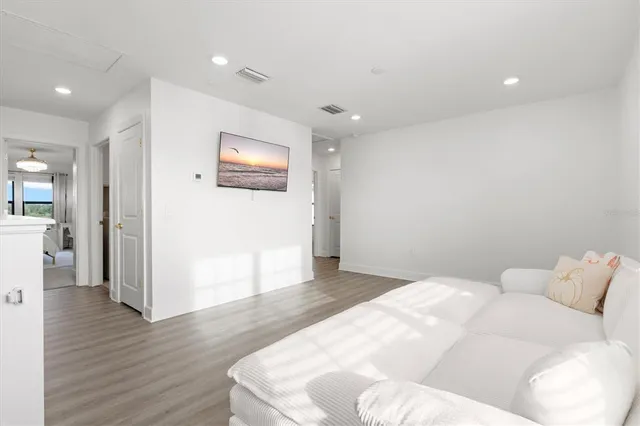 a view of a bedroom with baby crib and a window