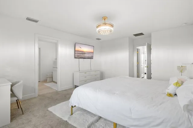 a view of a house with big yard plants and large trees