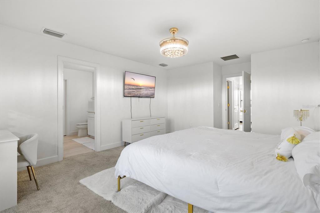 16235 Pine Mist Drive Bradenton, FL 34211 - Photo 25 of 100 a bedroom with a bed and a chandelier