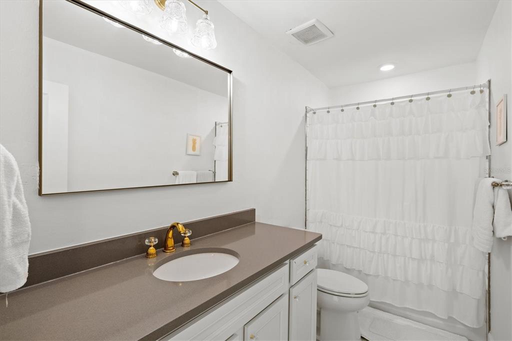 16235 Pine Mist Drive Bradenton, FL 34211 - Photo 31 of 100 a bathroom with a granite countertop sink toilet mirror and vanity