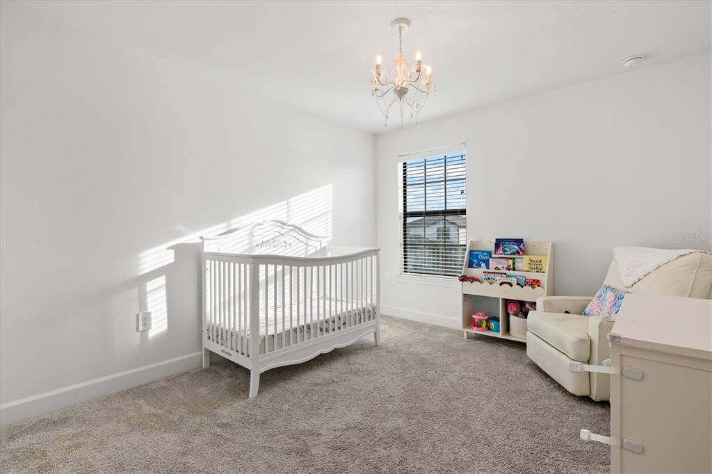 16235 Pine Mist Drive Bradenton, FL 34211 - Photo 32 of 100 a view of a bedroom with baby crib and a window