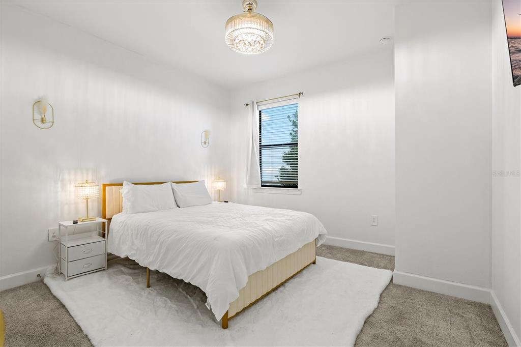 16235 Pine Mist Drive Bradenton, FL 34211 - Photo 34 of 100 a bedroom with a bed and a window