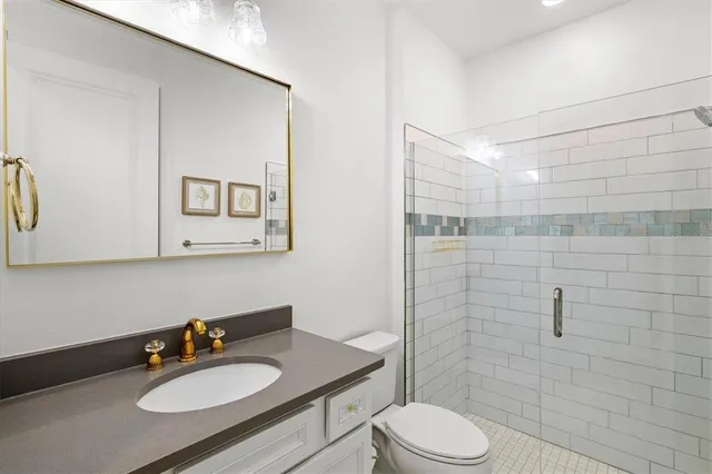 a view of a patio with a table and chairs under an umbrella with palm trees