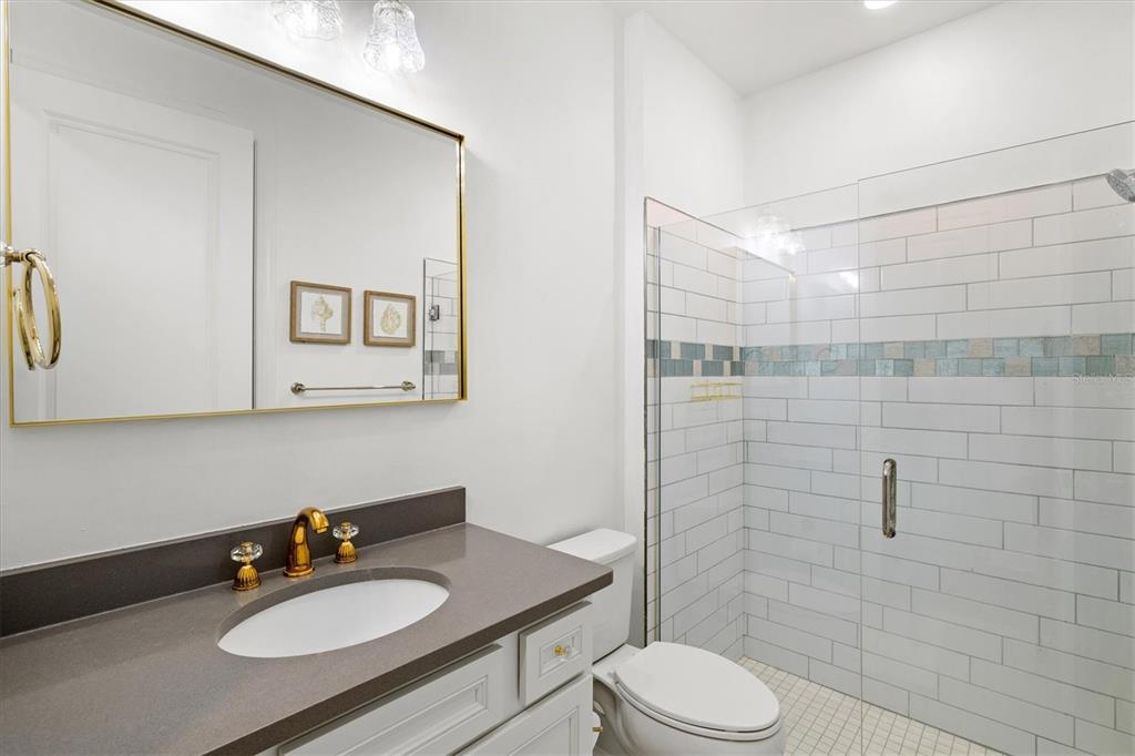 16235 Pine Mist Drive Bradenton, FL 34211 - Photo 36 of 100 a bathroom with a sink toilet a mirror and shower