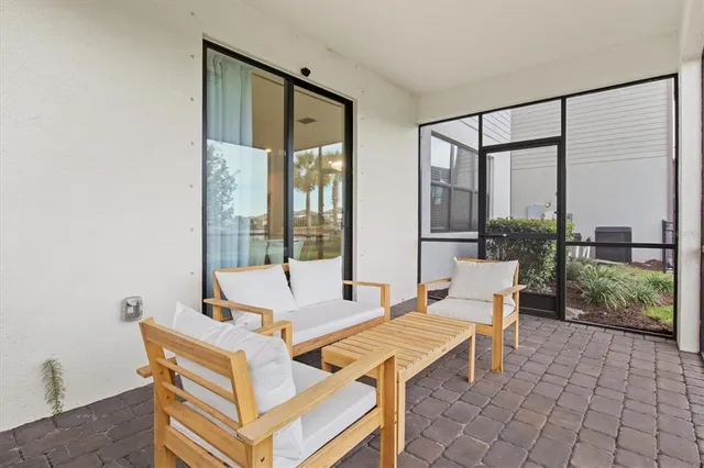 a view of a swimming pool with a patio and a yard