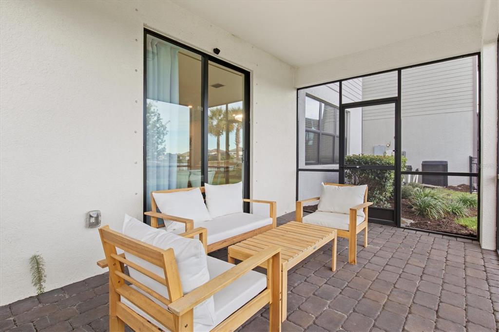 16235 Pine Mist Drive Bradenton, FL 34211 - Photo 38 of 100 a outdoor space with the couches and dining table with garden view