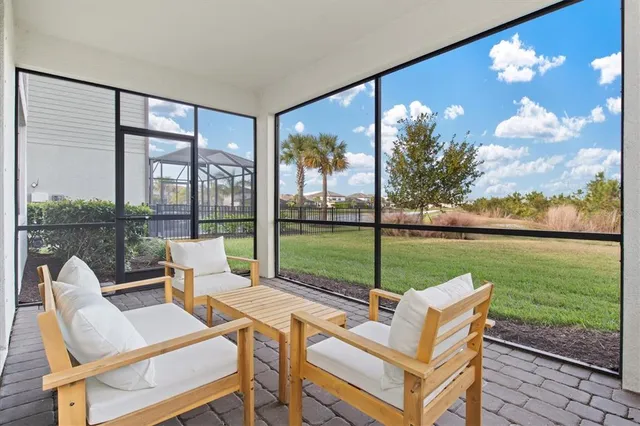 a view of a house with backyard porch and sitting area