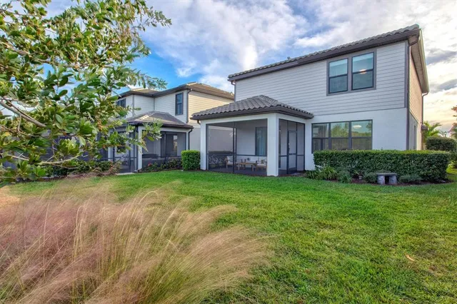a view of a house with swimming pool and sitting area