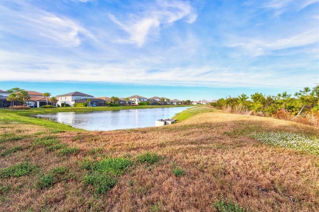 16235 Pine Mist Drive Bradenton, FL 34211 - Photo 46 of 100 a view of a lake with houses in the back