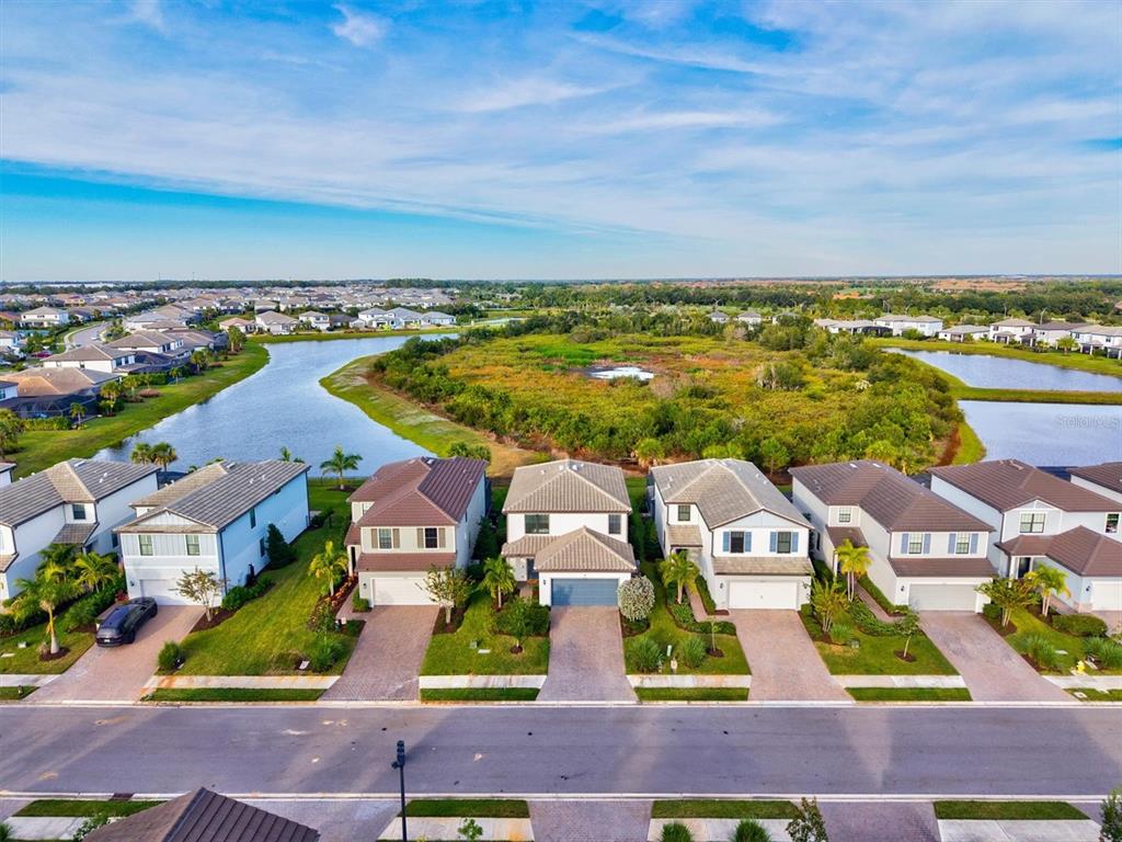 16235 Pine Mist Drive Bradenton, FL 34211 - Photo 48 of 100 an aerial view of residential houses with outdoor space and ocean view