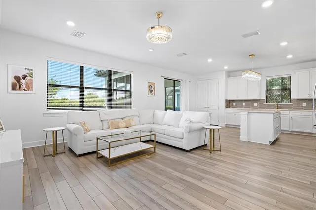 a living room with furniture and kitchen view