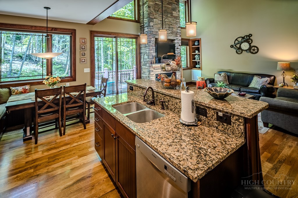 485 Woodlake Loop Road Elk Park, NC 28622 - Photo 11 of 44 a kitchen with a sink a counter and chairs