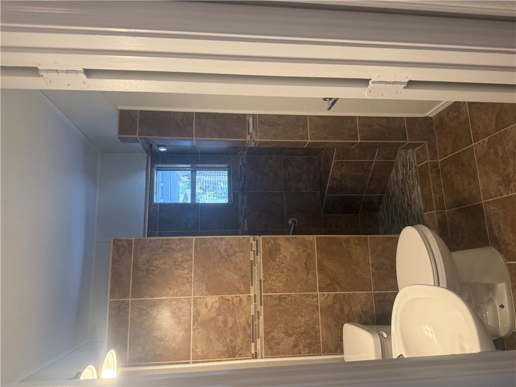 709 Churchill Drive Bryan, TX 77801 - Photo 11 of 31 a white toilet sitting next to a bathroom sink