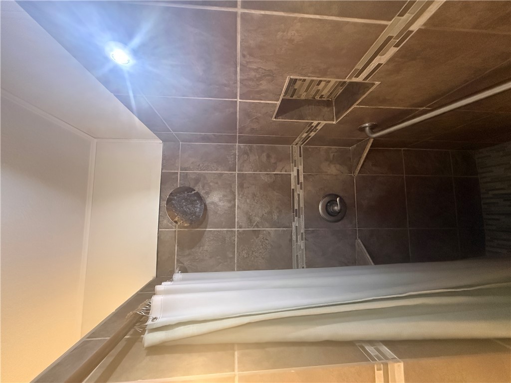 709 Churchill Drive Bryan, TX 77801 - Photo 12 of 31 a bathroom with a shower