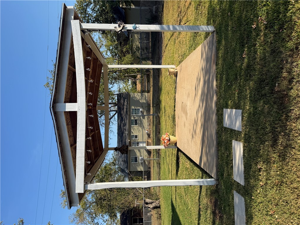709 Churchill Drive Bryan, TX 77801 - Photo 24 of 31 a view of a patio with table and chairs with wooden floor and fence