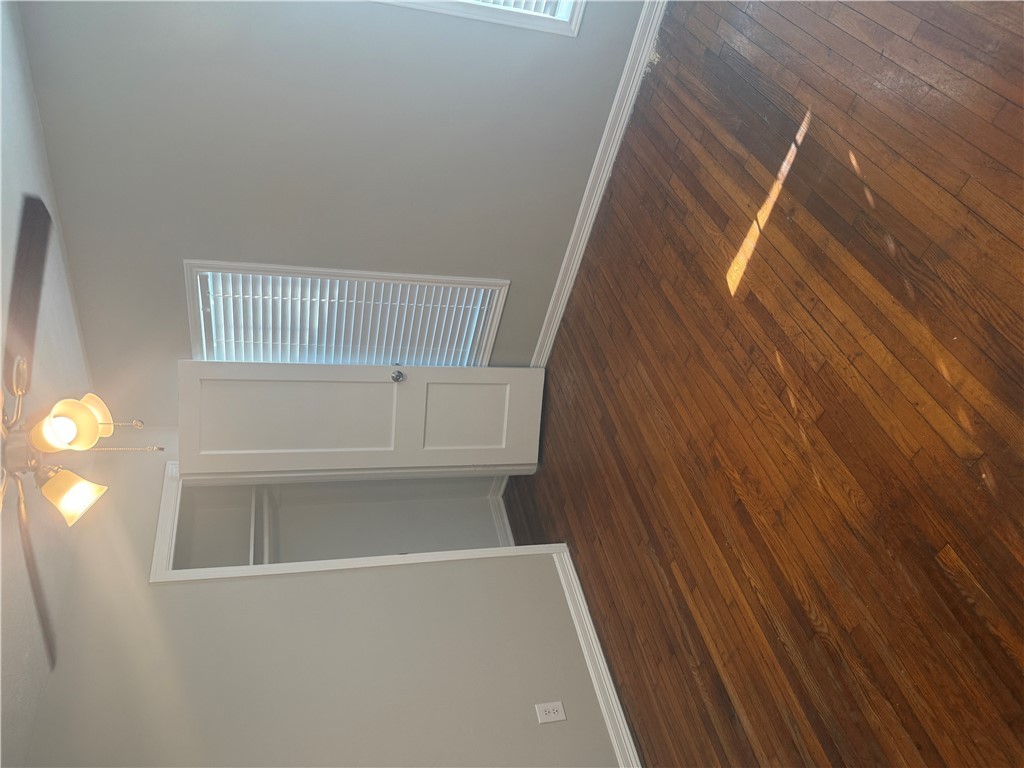 709 Churchill Drive Bryan, TX 77801 - Photo 8 of 31 an empty room with wooden floor & windows