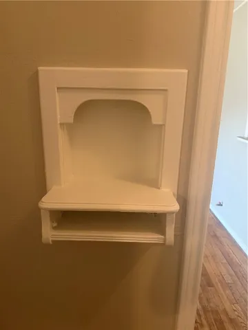 an empty room with wooden floor & windows