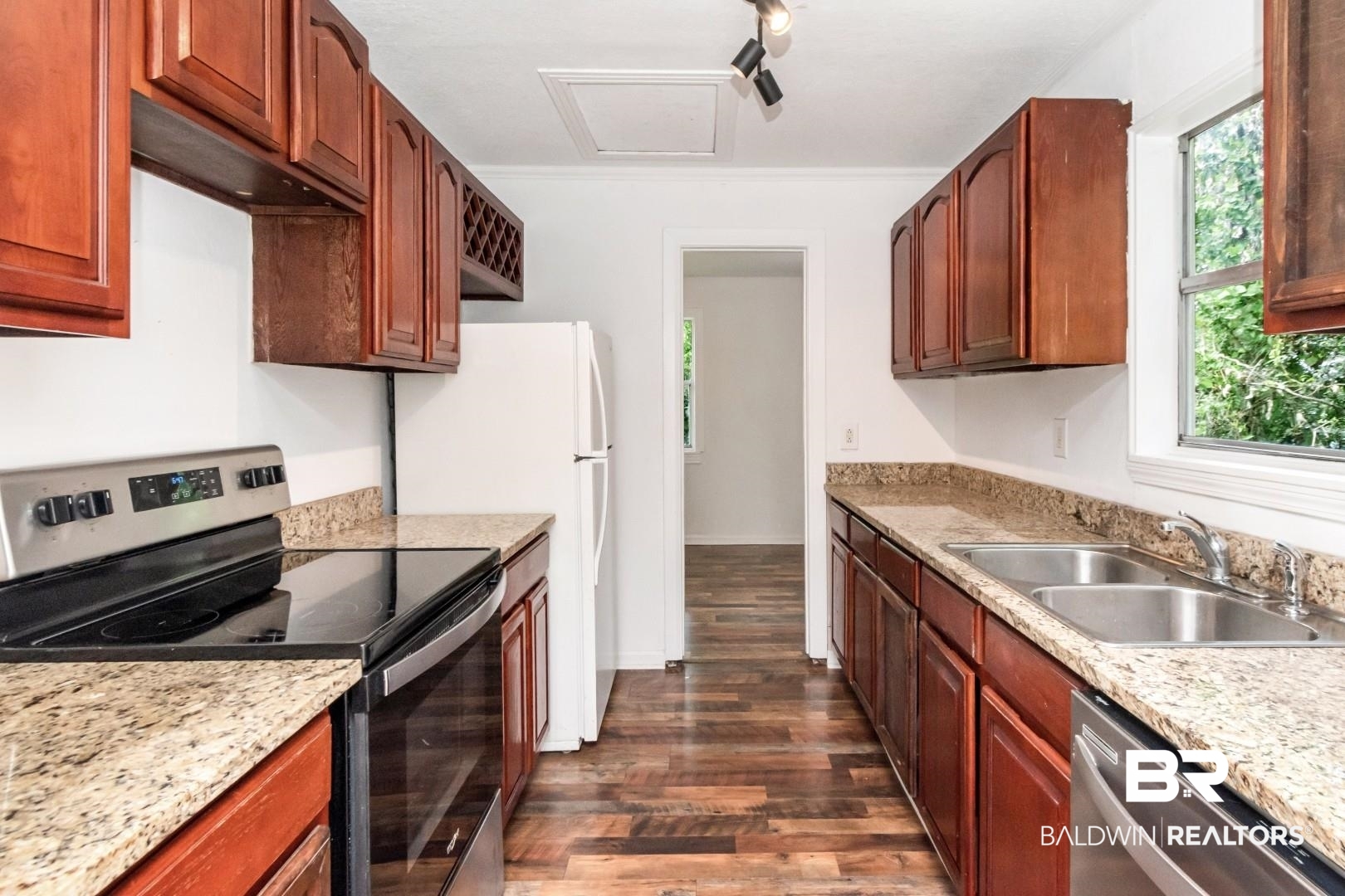2905A McFarland Road, Unit F Mobile, AL 36695 - Photo 10 of 29 Kitchen featuring wood-finish flooring, granite countertops, wood cabinetry, a stainless steel electric range, and a double-basin stainless steel sink with a window above