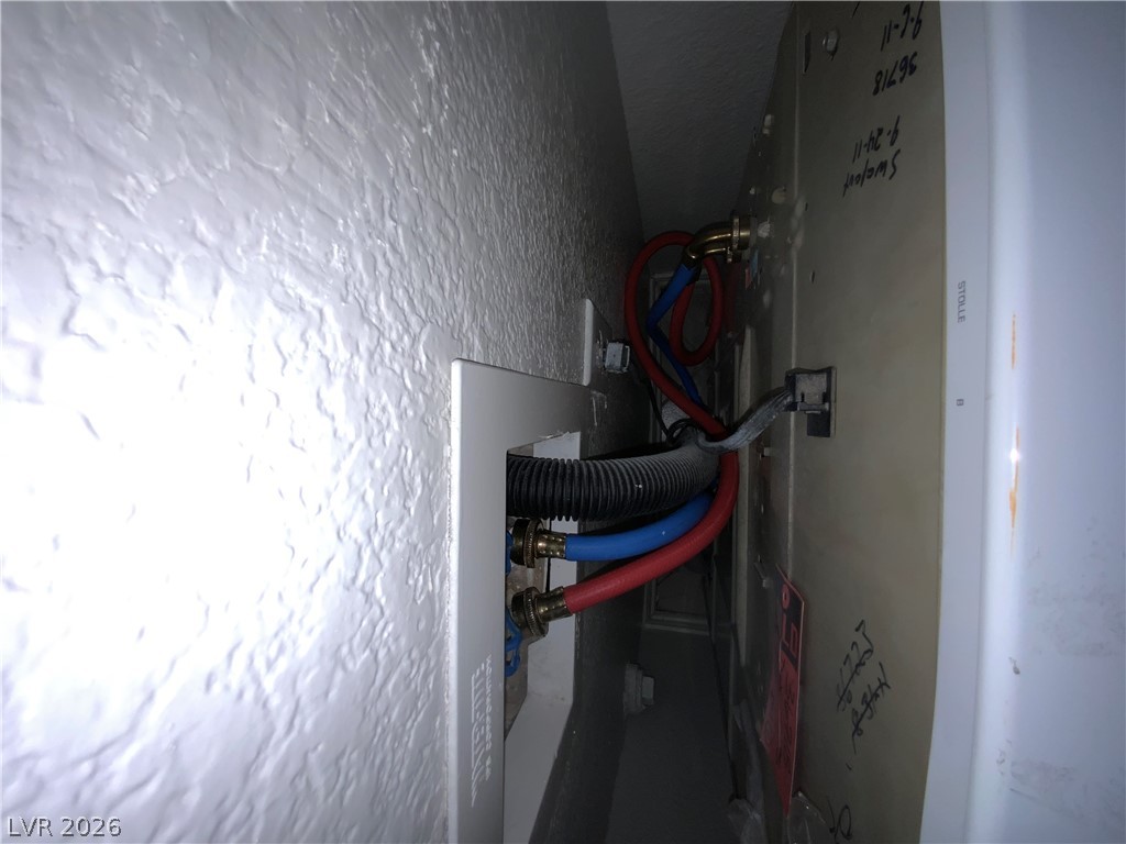 7400 West Flamingo Road, Unit 1039 Las Vegas, NV 89147 - Photo 22 of 40 Essential hookups provide seamless washer and dryer installation in this functional laundry space.