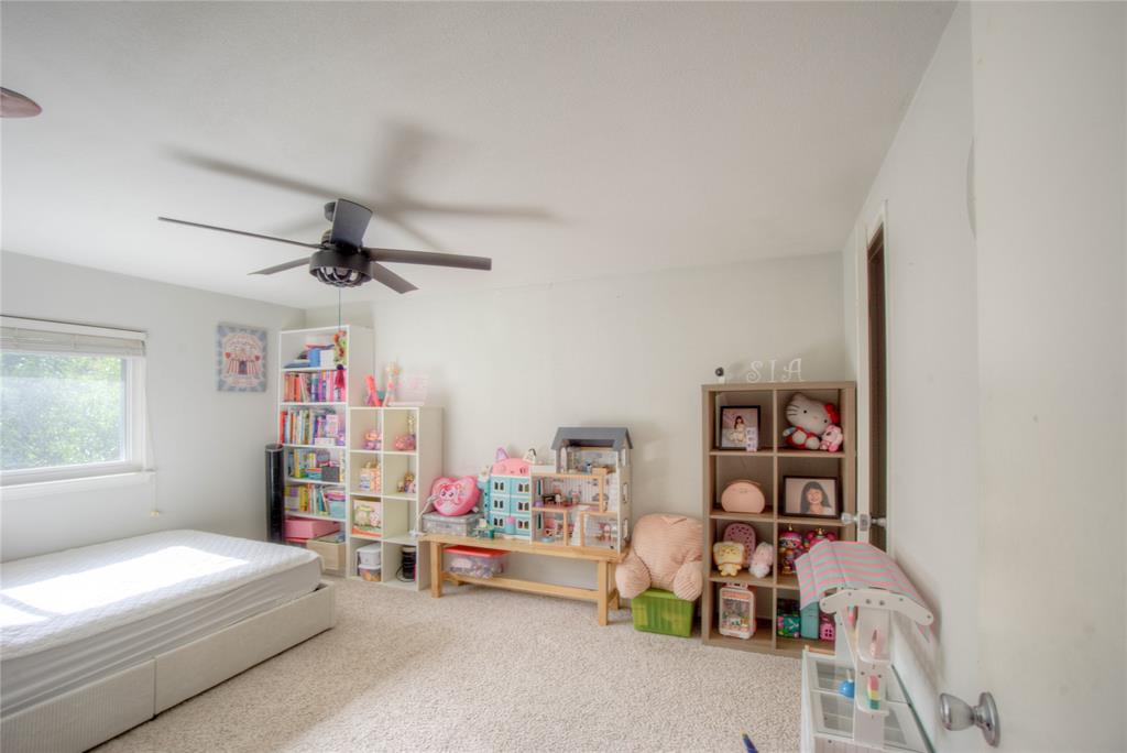 12231 Veronica Road Farmers Branch, TX 75234 - Photo 18 of 26 Carpeted room with a ceiling fan, a window, and a white door frame