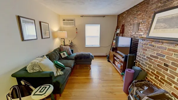 a living room with furniture and a mirror