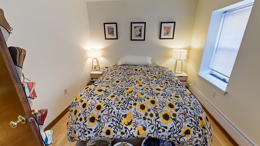 267 Main, Unit 3A Boston, MA 02129 - Photo 4 of 9 a bedroom with a bed and a window