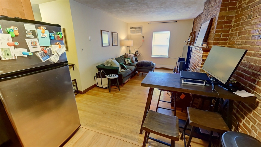 267 Main, Unit 3A Boston, MA 02129 - Photo 8 of 9 a living room with furniture and a flat screen tv