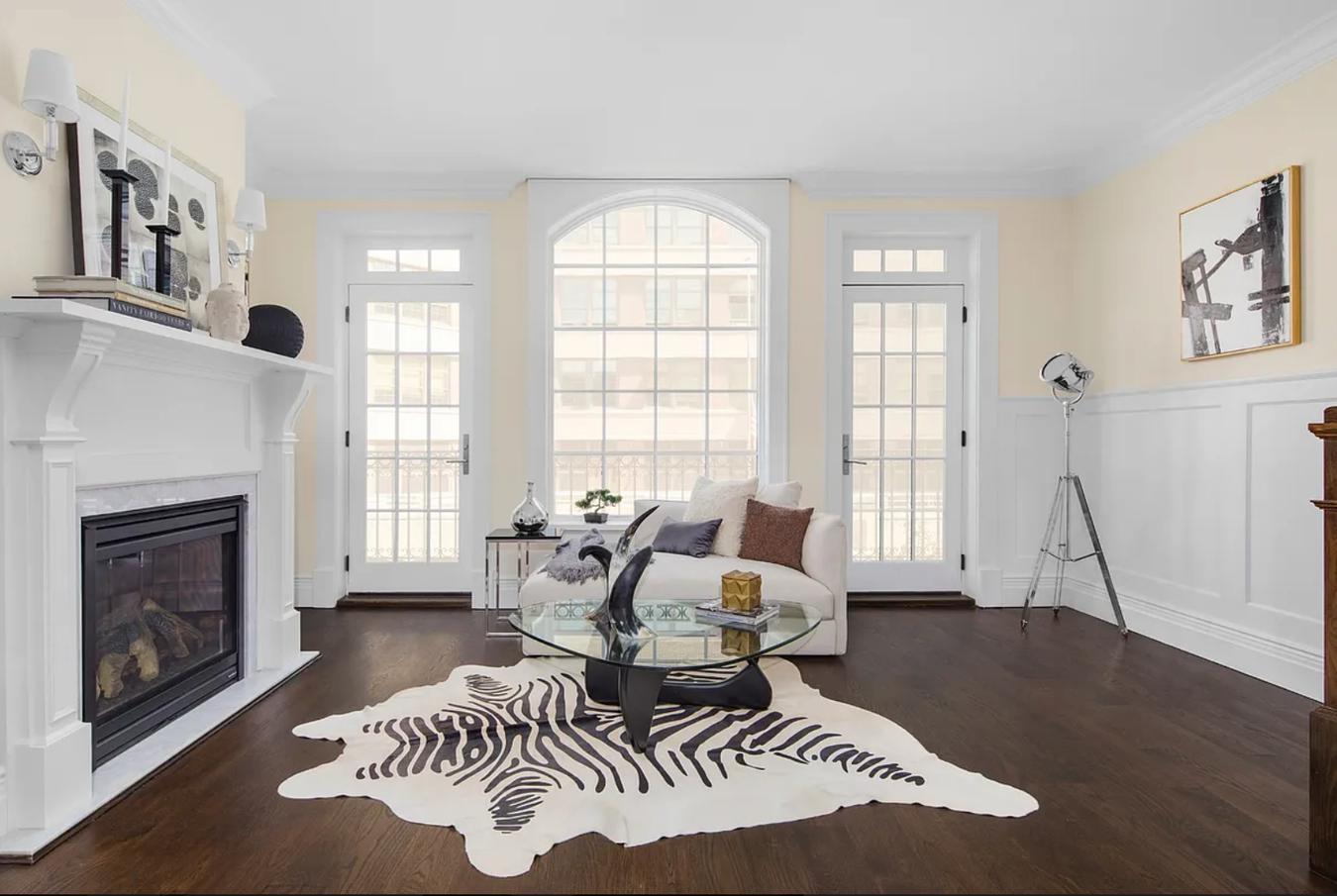 236 West 24th Street, Unit PH Manhattan, NY 10011 - Photo 5 of 14 a living room with furniture a fireplace and a large window