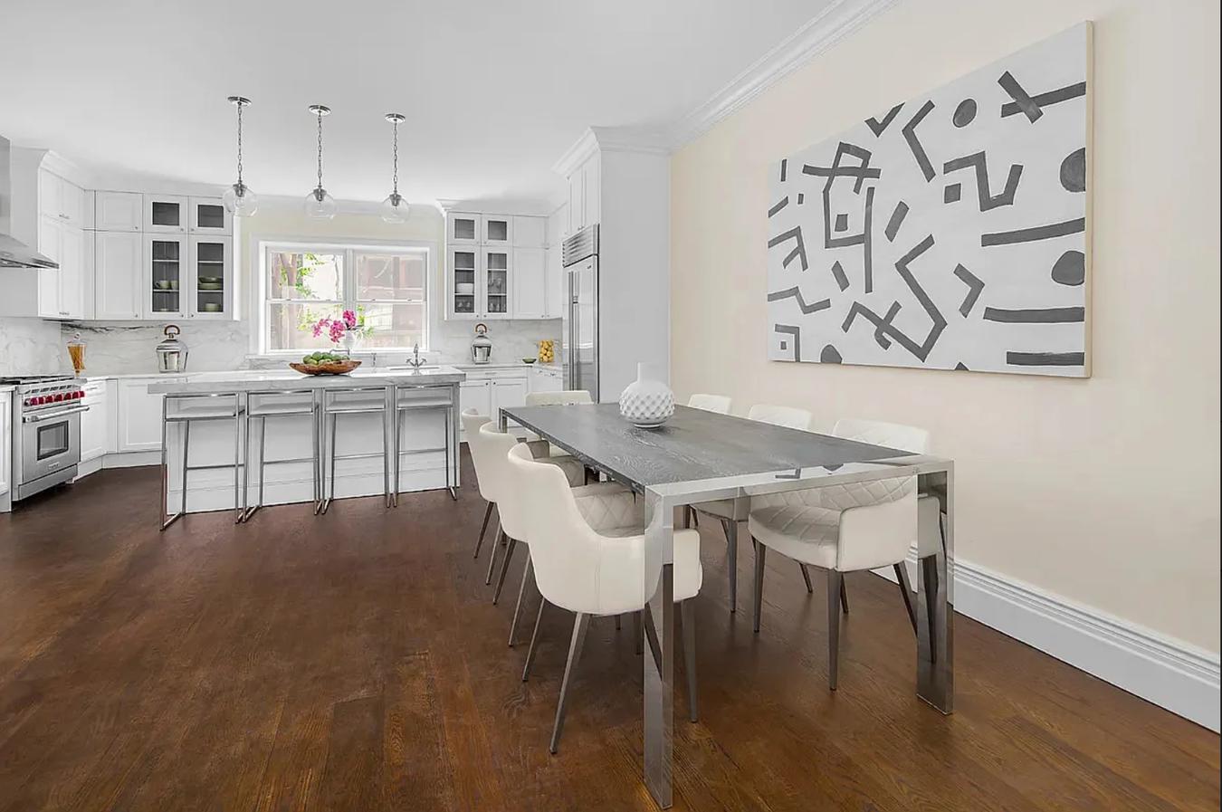 236 West 24th Street, Unit PH Manhattan, NY 10011 - Photo 6 of 14 a kitchen with stainless steel appliances a dining table chairs and a refrigerator