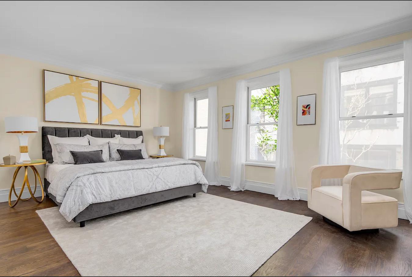 236 West 24th Street, Unit PH Manhattan, NY 10011 - Photo 8 of 14 a spacious bedroom with a bed and a couch next to a window