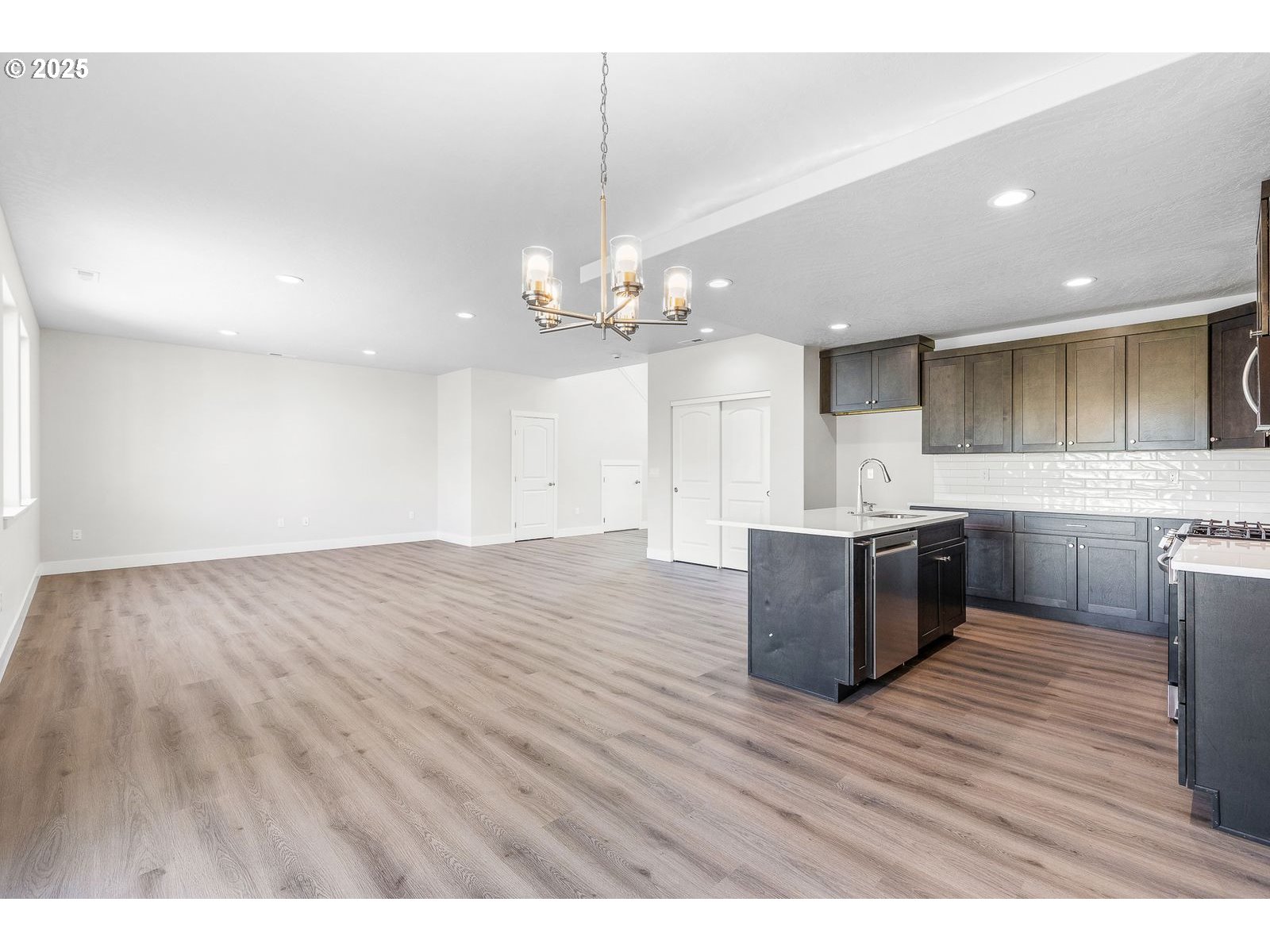 104 Tiber Court Boardman, OR 97818 - Photo 11 of 33 a view of kitchen with granite countertop cabinets and wooden floor
