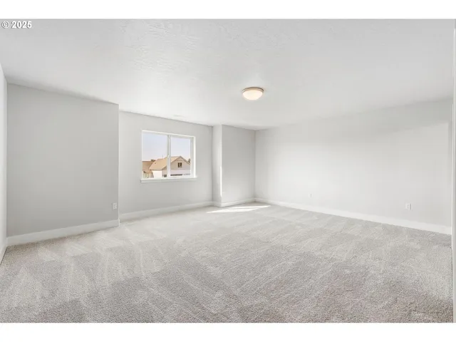 a view of an empty room and a window