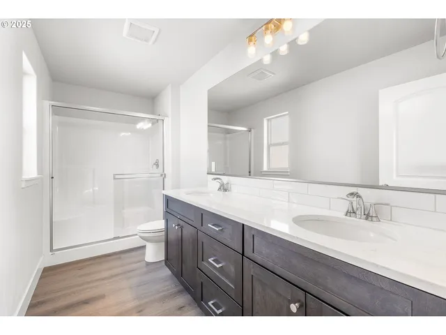 a bathroom with a granite countertop sink mirror and double