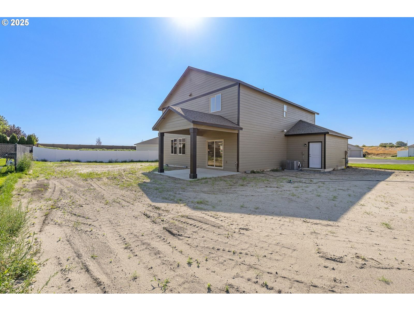 104 Tiber Court Boardman, OR 97818 - Photo 24 of 33 a view of a house with a dirt road and a building