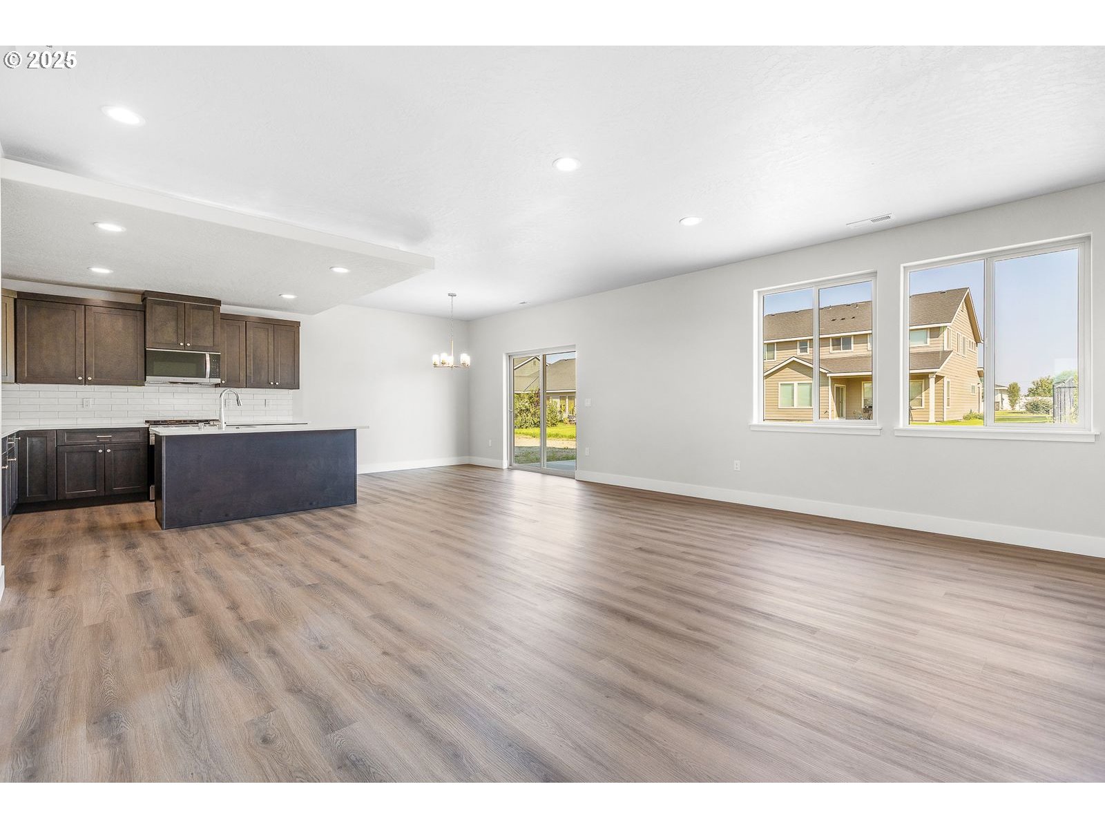 104 Tiber Court Boardman, OR 97818 - Photo 5 of 33 a view of an empty room with wooden floor and a window