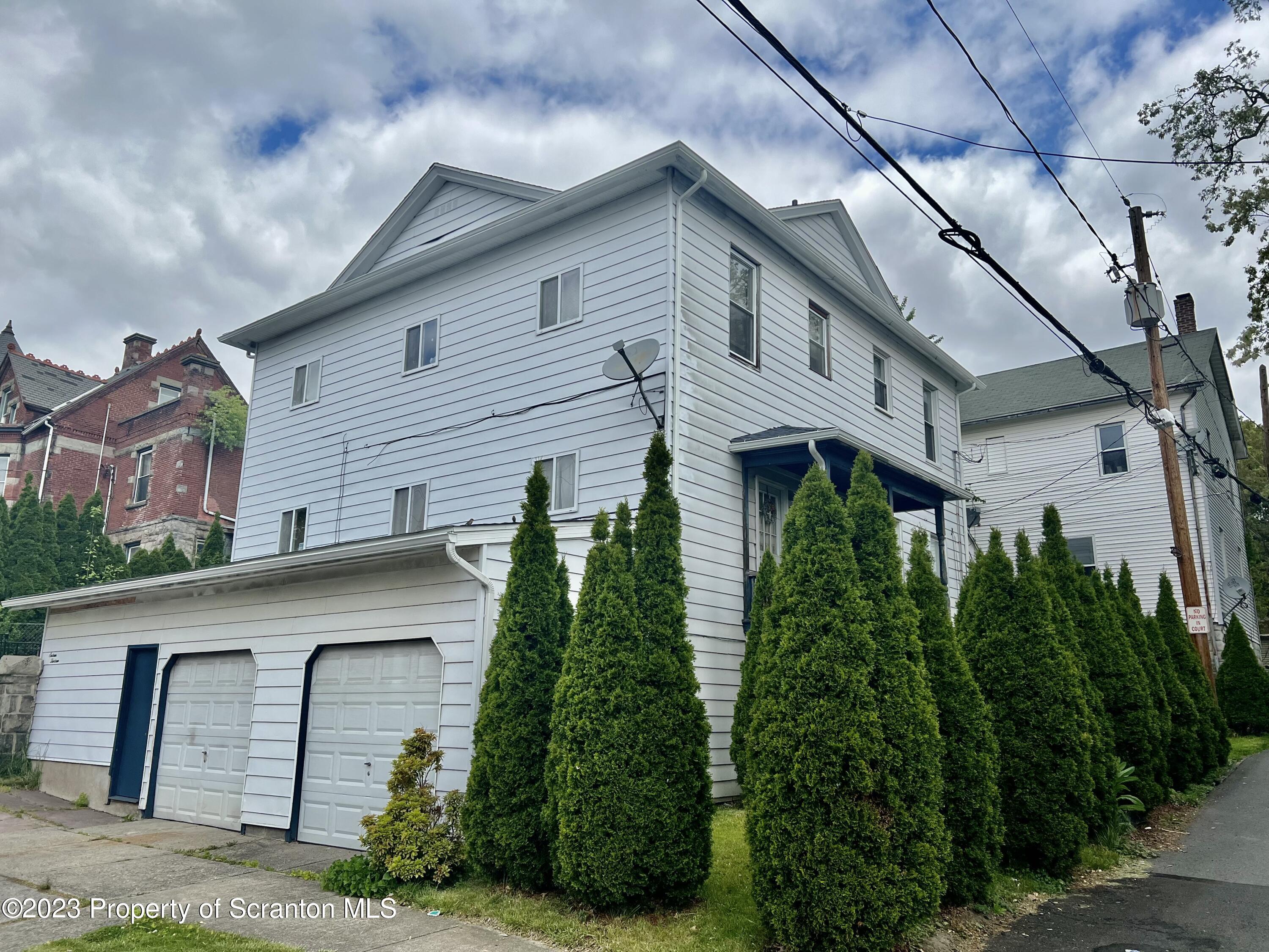 1613 Olive Street Scranton, PA 18510 - Photo 1 of 22 a view of a white house next to a yard