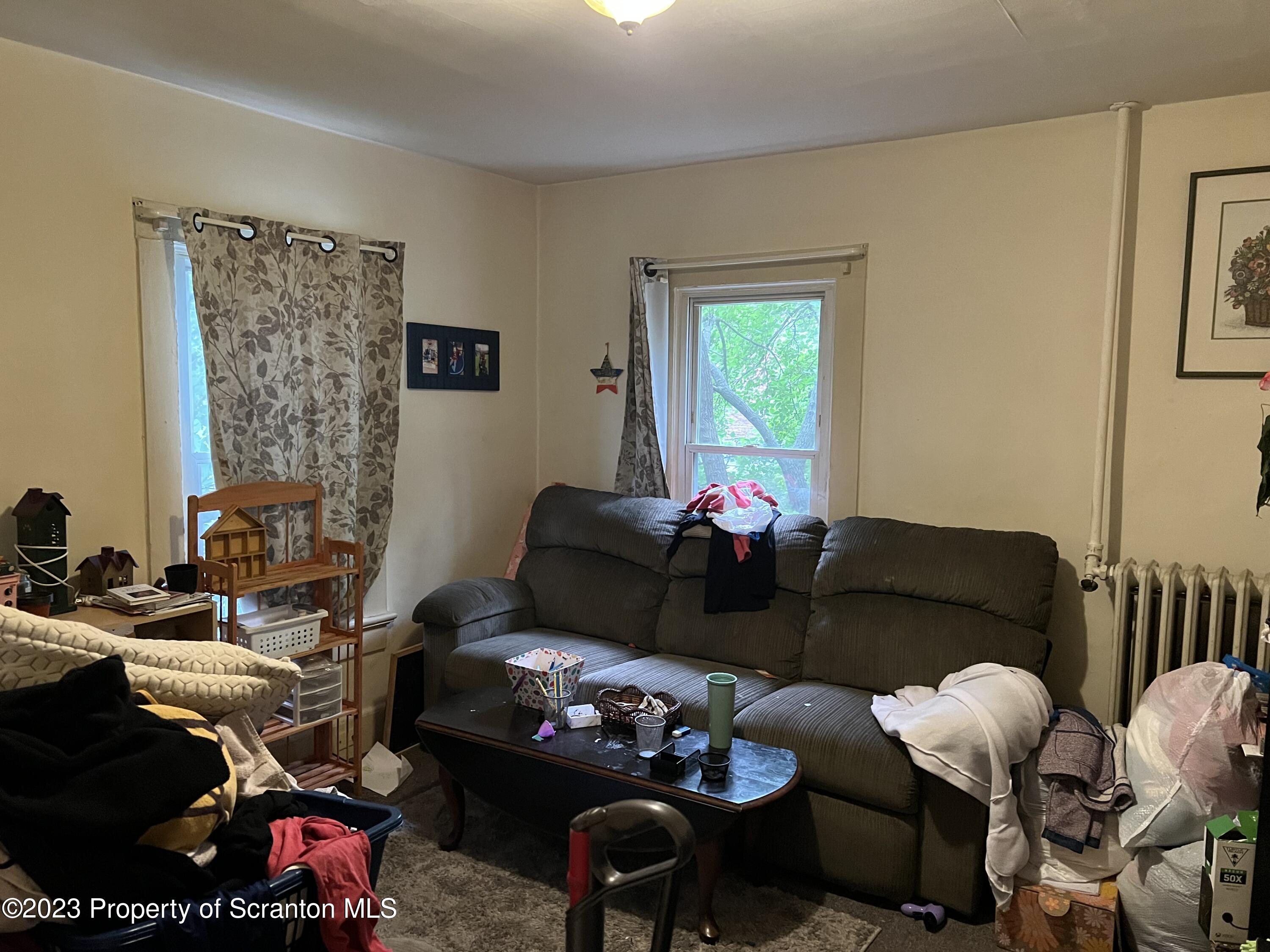 1613 Olive Street Scranton, PA 18510 - Photo 11 of 22 a living room with furniture and a window